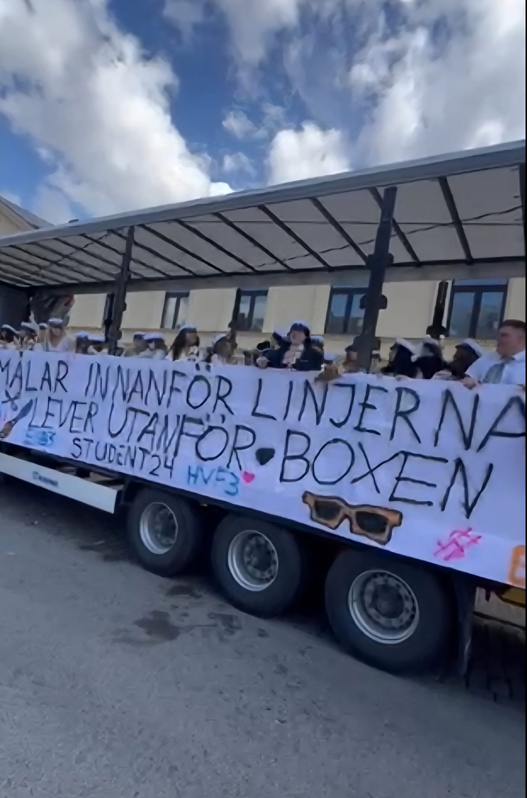 A truck filled with jubilant high school graduates dancing and celebrating their graduation